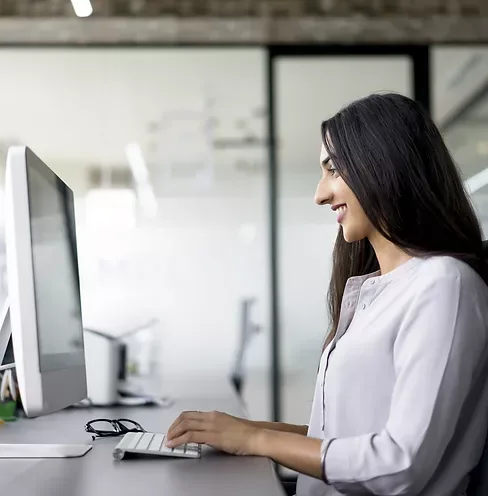 A woman working at a desktop computer